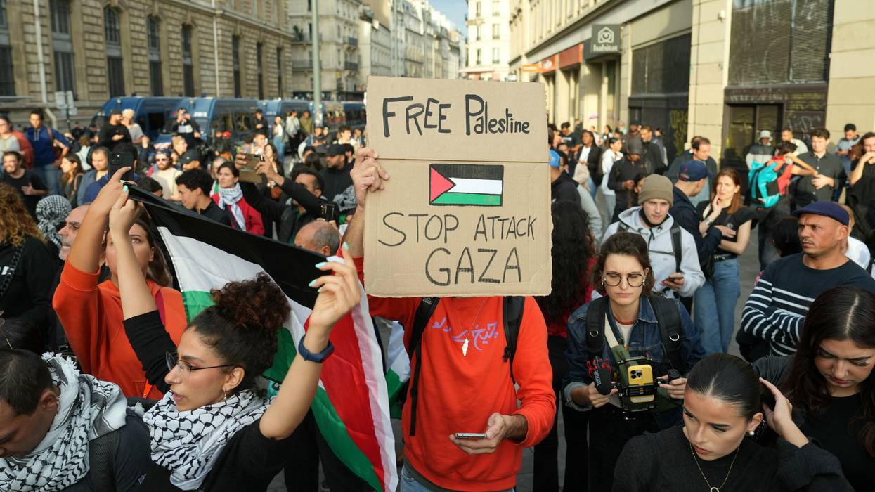 Protestors hold Palestinian flags and placards
