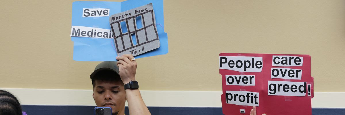 protestors hold signs