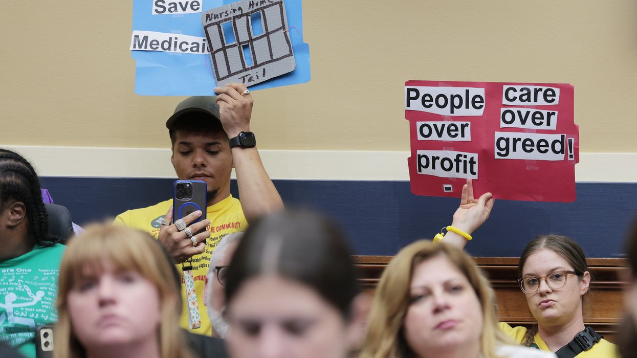 protestors hold signs