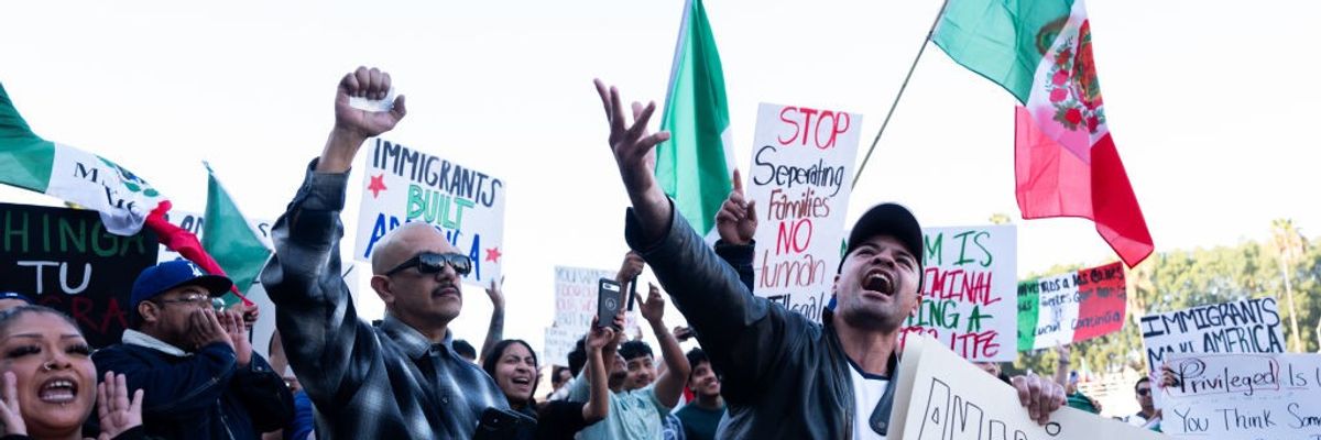 Protestors wave Mexican flags and hold signs