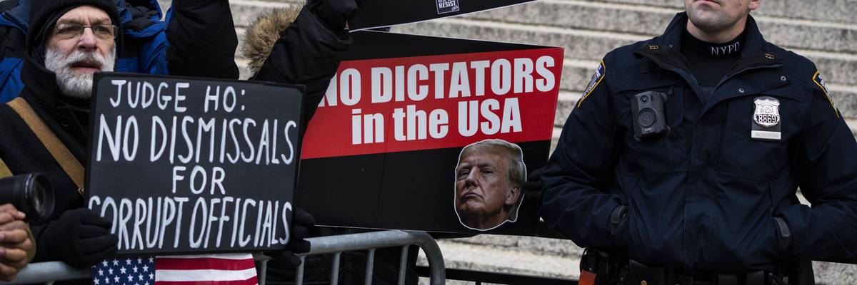 Protestors with a sign that reads "Judge Ho: No Dismissal for Corrupt Officials."