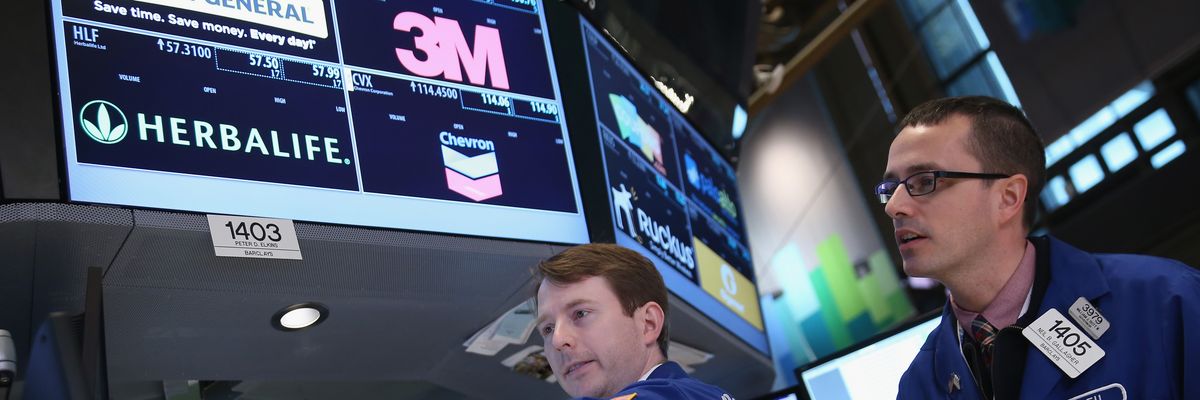 raders work the floor of the New York Stock Exchange as Helbalife stocks are traded on March 14, 2014 in New York City.