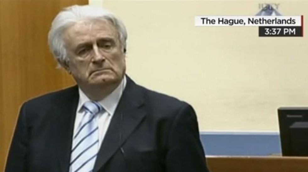 Radovan Karadzic stands as the tribunal's verdict is read.  (Photo: CNN video screengrab)