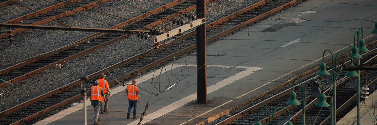 Rail workers walk the tracks at Union Station