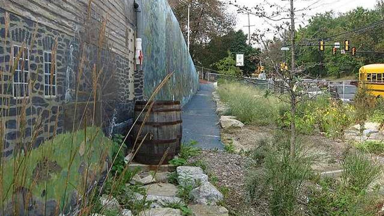 Rain barrel in yard.