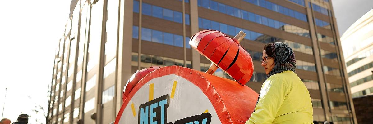 Rally organizers carry away props following a protest outside the Federal Communication Commission building against the end of net neutralityrules December 14, 2017 in Washington, DC.