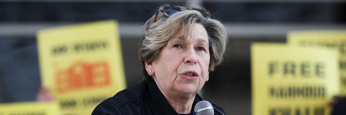 Randi Weingarten holds a microphone