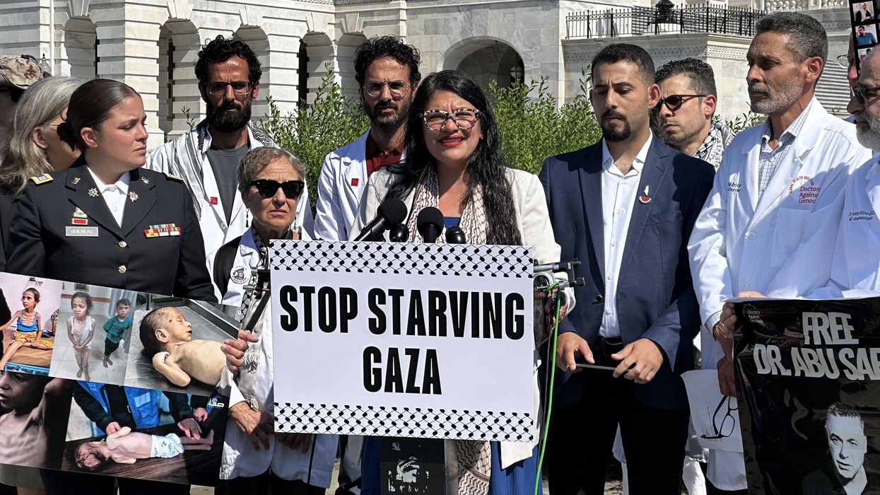 Rashida Tlaib holds a sign reading, "Stop Starving Gaza"