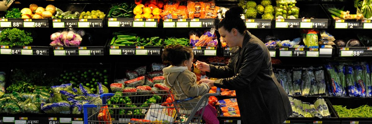 Rebecka Ortiz offers a sample of pasta to her 3-year-old daughter at the grocery store where she was using her SNAP benefits to stock up on food for her family on March 1, 2013 in Woonsocket, Rhode Island. (Photo: Michael S. Williamson/Washington Post via Getty Images)