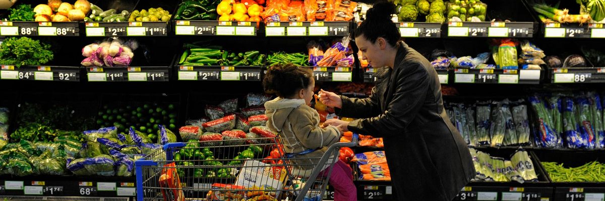 Rebecka Ortiz offers a sample of pasta to her 3-year-old daughter at the grocery store where she was using her SNAP benefits to stock up on food for her family on March 1, 2013 in Woonsocket, Rhode Island. (Photo: Michael S. Williamson/Washington Post via Getty Images)