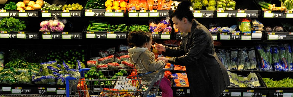 Rebecka Ortiz offers a sample of pasta to her 3-year-old daughter at the grocery store where she was using her SNAP benefits to stock up on food for her family on March 1, 2013 in Woonsocket, Rhode Island.