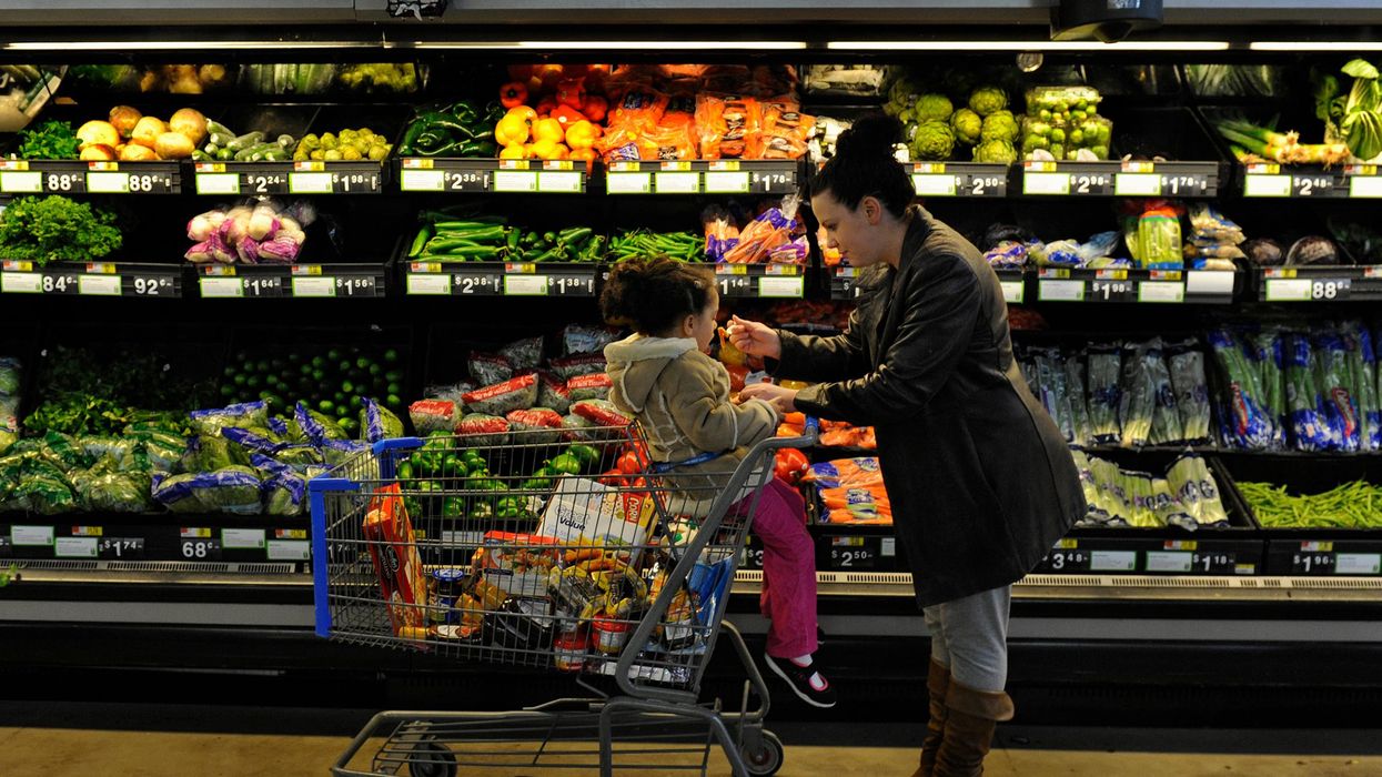 Rebecka Ortiz offers a sample of pasta to her 3-year-old daughter at the grocery store where she was using her SNAP benefits to stock up on food for her family on March 1, 2013 in Woonsocket, Rhode Island.