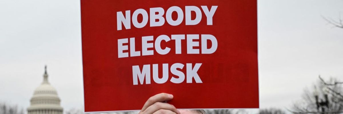 Red sign says, "Nobody elected Musk"