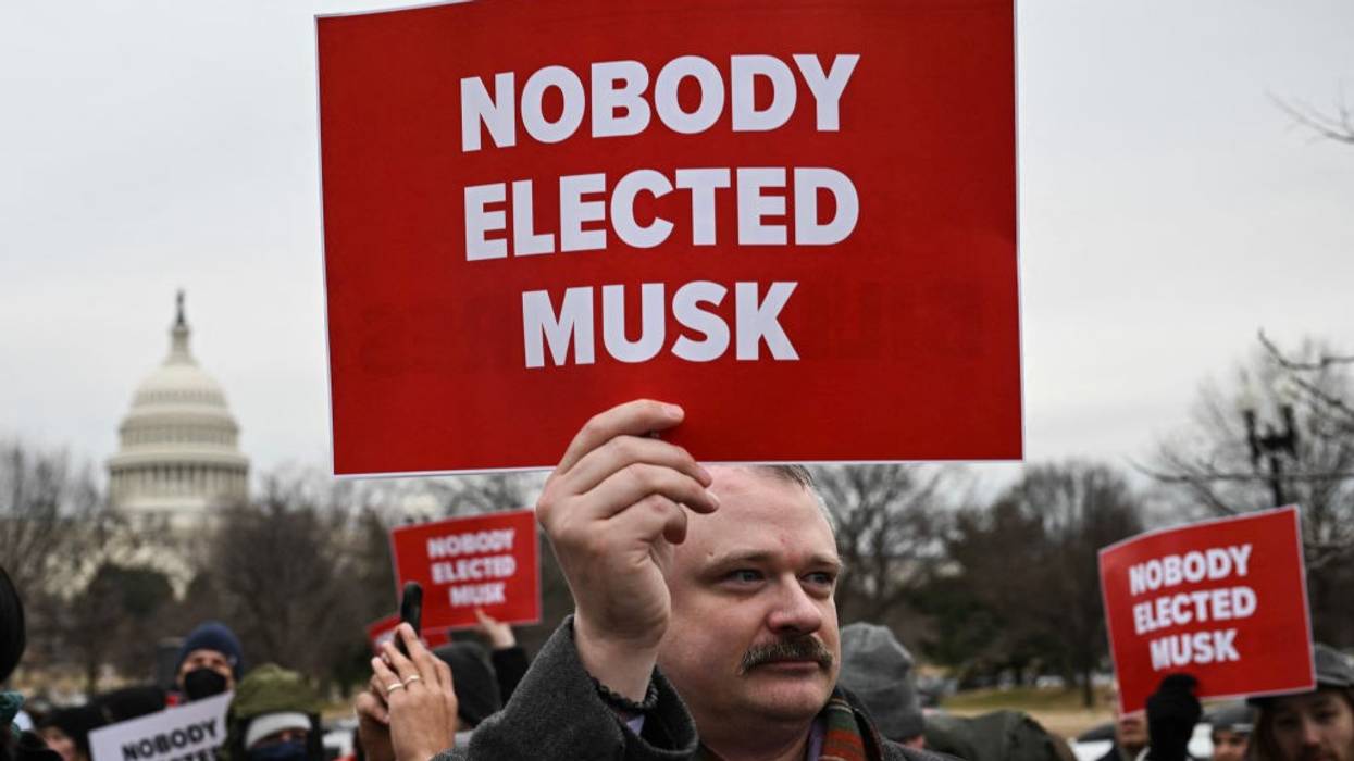 Red sign says, "Nobody elected Musk"