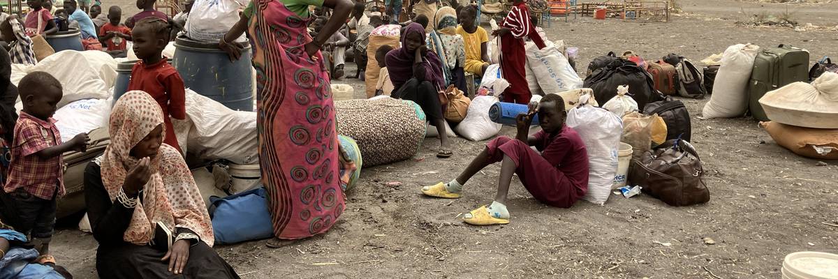 Refugees from Sudan wait to be transported to the transit camp in the town of Renk