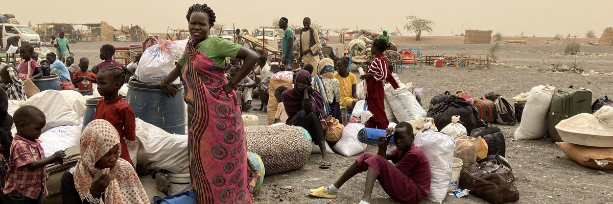 Refugees from Sudan wait to be transported to the transit camp in the town of Renk