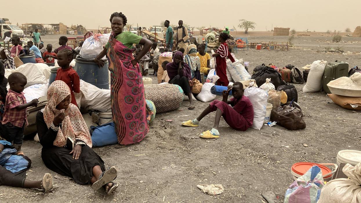 Refugees from Sudan wait to be transported to the transit camp in the town of Renk