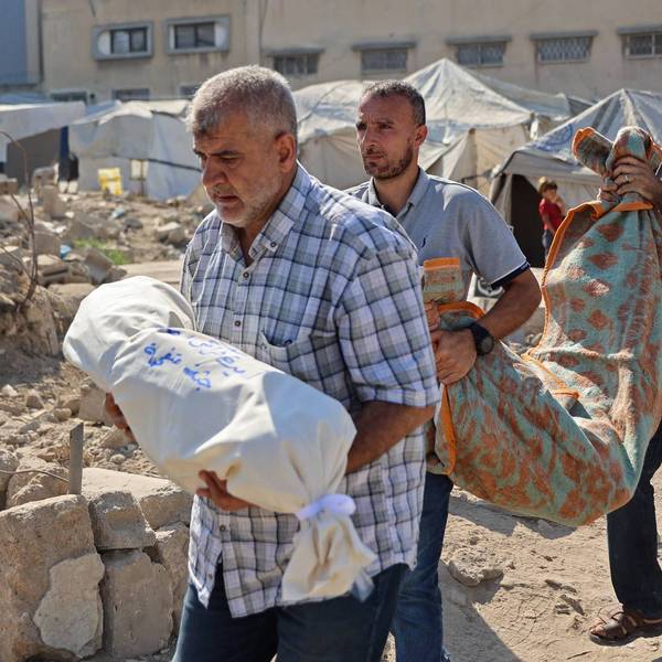 Relative of people killed in an Israeli airstrike on the home of a family carry victims' shrouded bodies