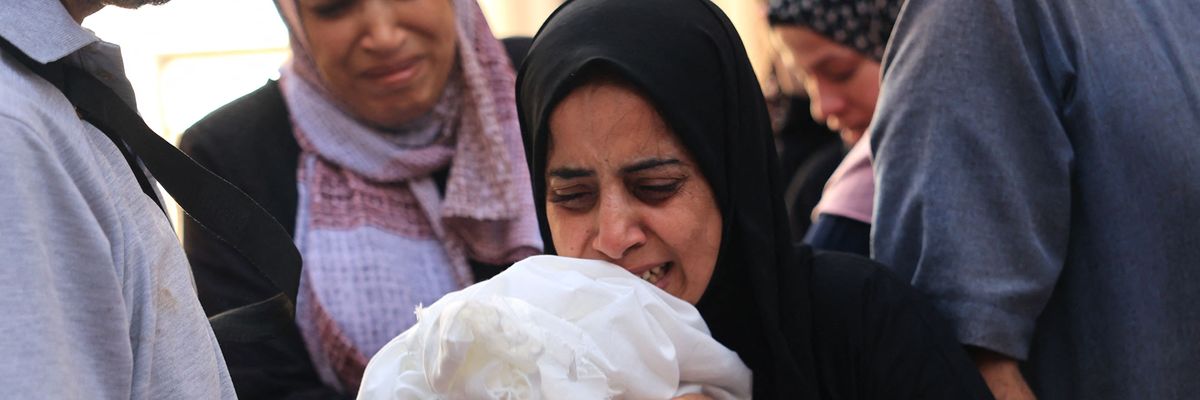 Relatives carry the body of 8-month-old Ahmed Barhom during a funeral 