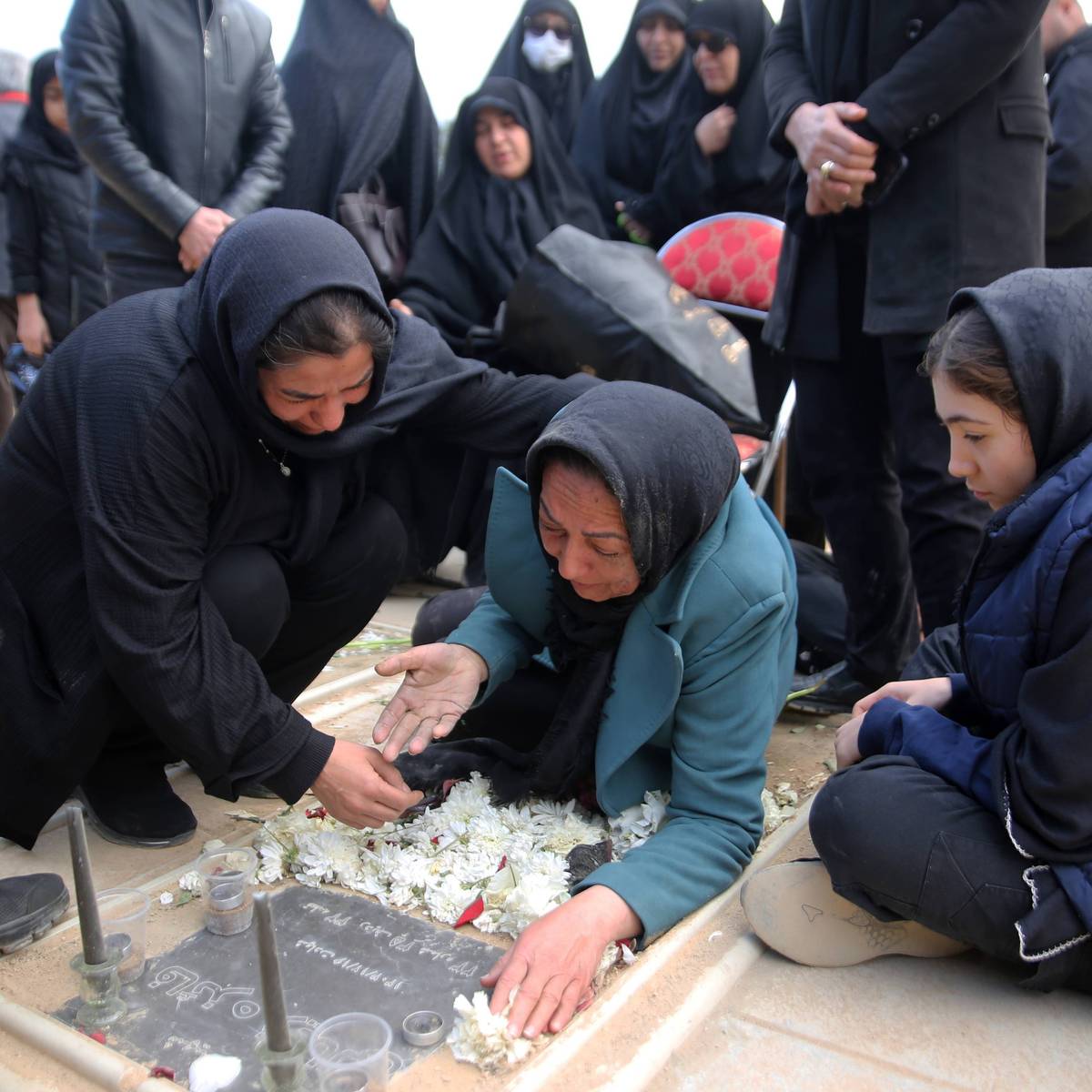 Relatives mourn as a funeral ceremony is held for people killed by US-Israeli airstrikes