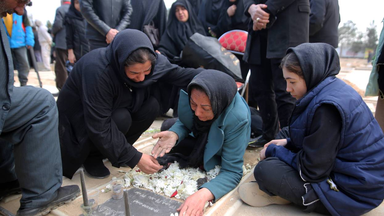 Relatives mourn as a funeral ceremony is held for people killed by US-Israeli airstrikes