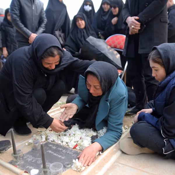 Relatives mourn as a funeral ceremony is held for people killed by US-Israeli airstrikes
