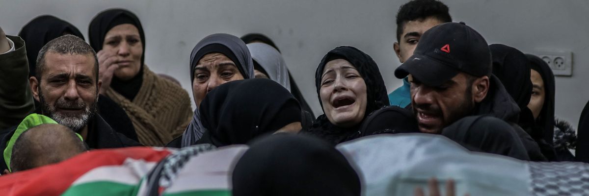 Relatives mourn over the body of Palestinian Yazan Al-Najmi