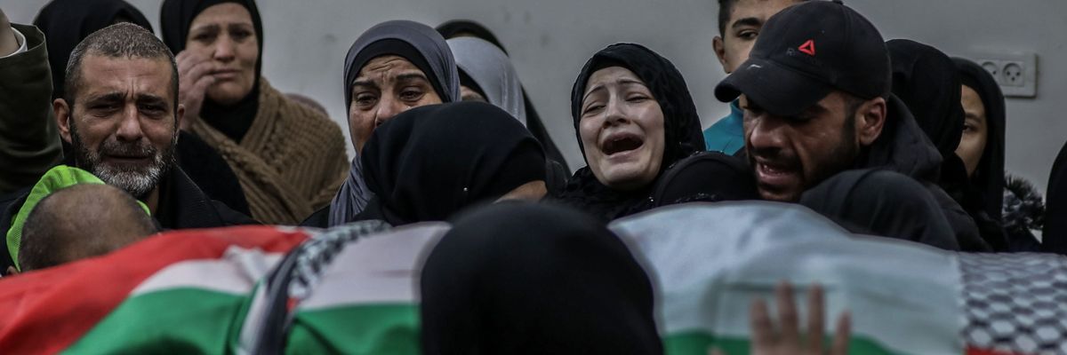 Relatives mourn over the body of Palestinian Yazan Al-Najmi
