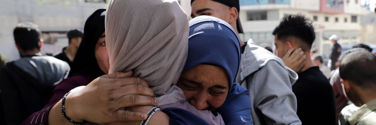 Relatives of Palestinians killed in an Israeli attack on Al-Wehda Street, Gaza City mourn their loss during a funeral ceremony in Gaza