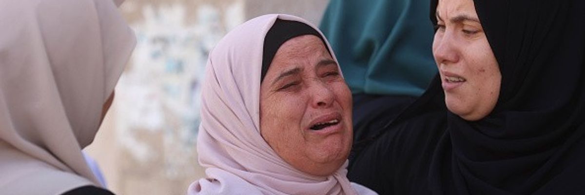 Relatives of Palestinians who lost their lives in an Israeli attack on Jenin refugee camp mourn