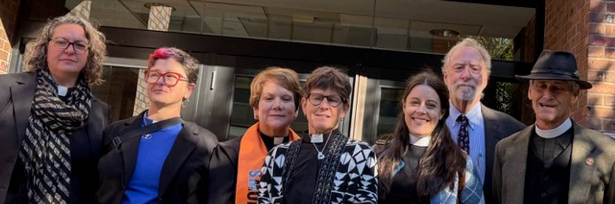 Religious leaders who conducted civil disobedience against ICE stand outside a courthouse.