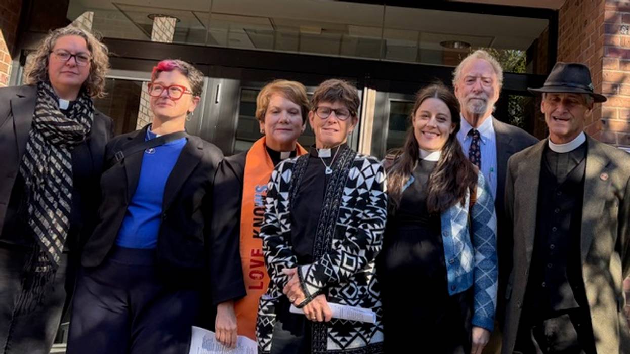 Religious leaders who conducted civil disobedience against ICE stand outside a courthouse.