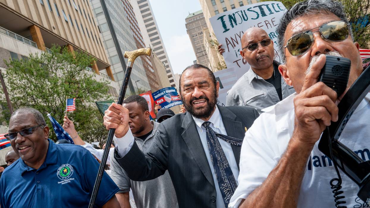 Rep. Al Green marches as part of a protest