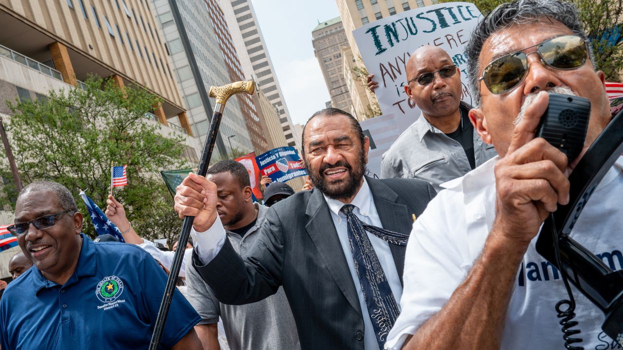 Rep. Al Green marches as part of a protest