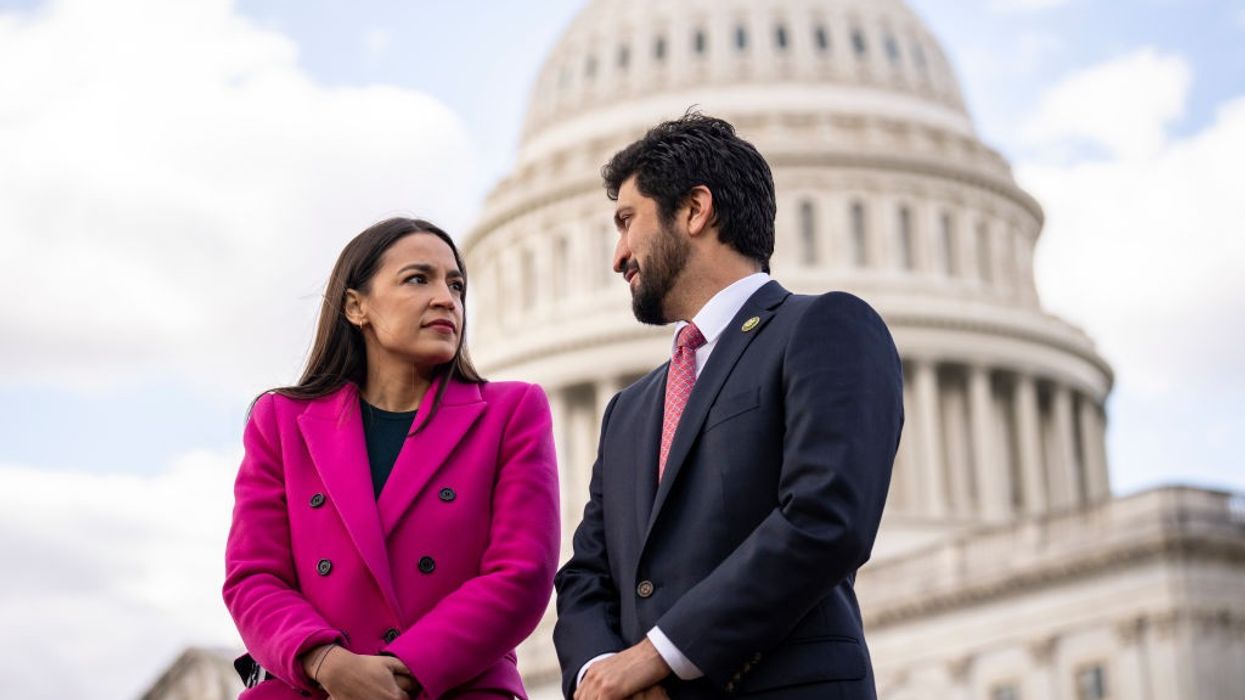 Rep. Alexandria Ocasio-Cortez speaks with Rep. Greg Casar outside the U.S. Capitol