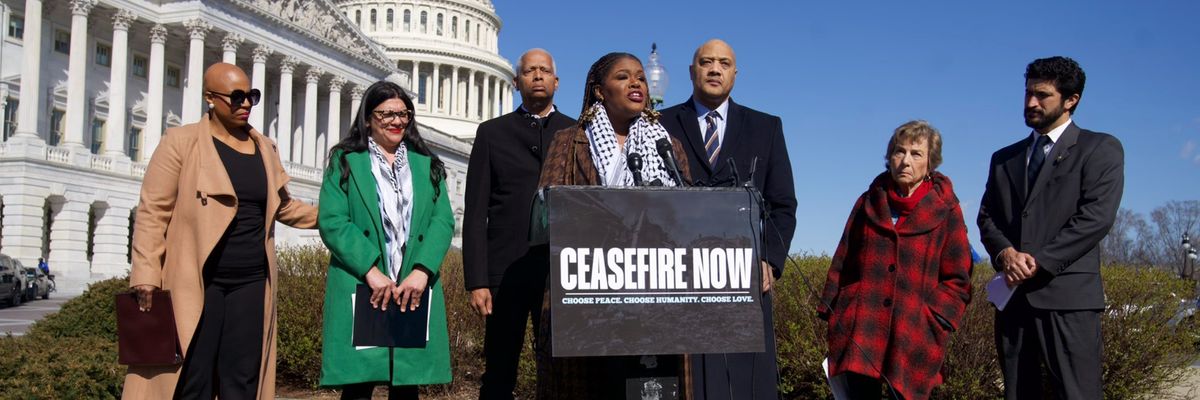 Rep. Cori Bush speaks outside the U.S. Capitol with a "cease-fire now" sign on the podium.