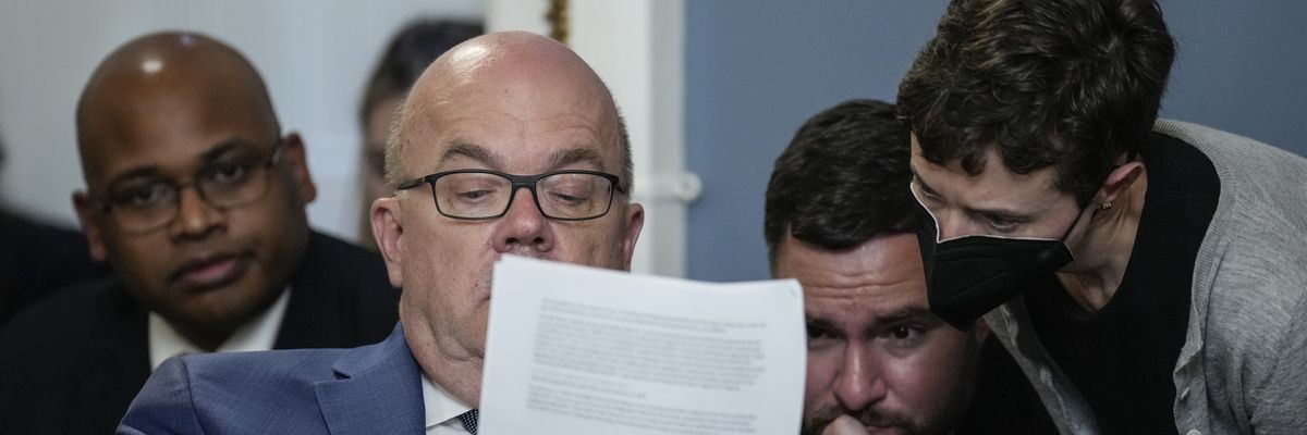 Rep. Jim McGovern looks over notes with staff during a House Rules Committee