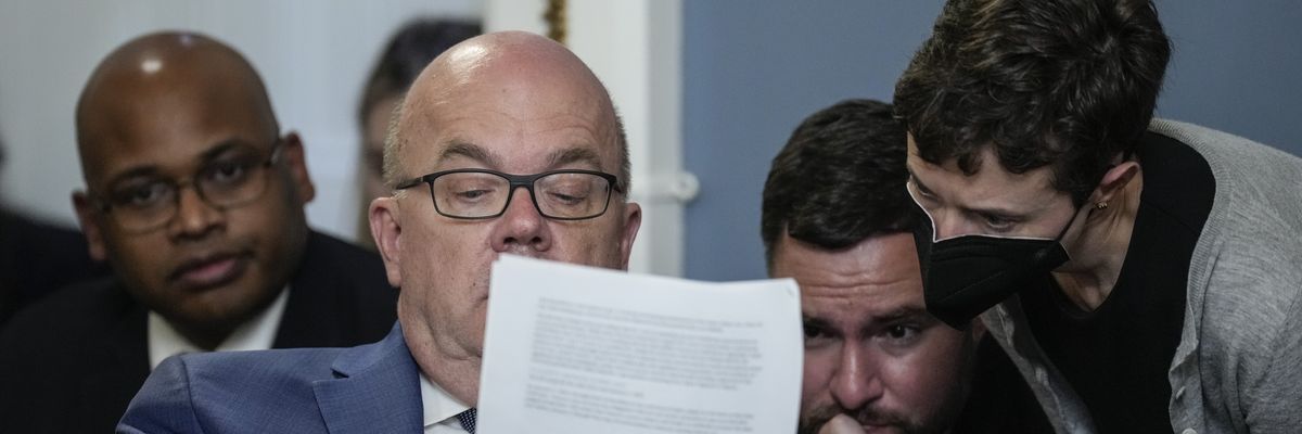 Rep. Jim McGovern looks over notes with staff during a House Rules Committee 