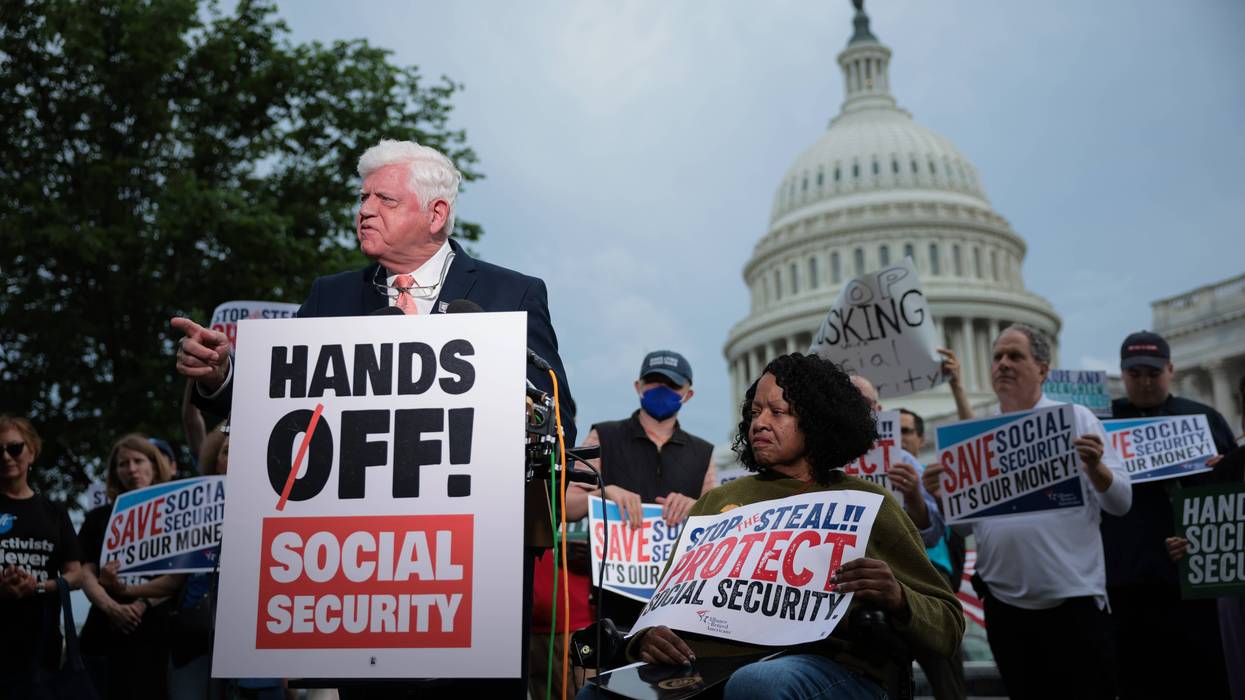Rep. John Larson stands with sign reading, "Hands off Social Security."