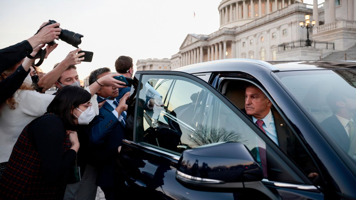Reporters trying to get a comment from Sen. Joe Manchin