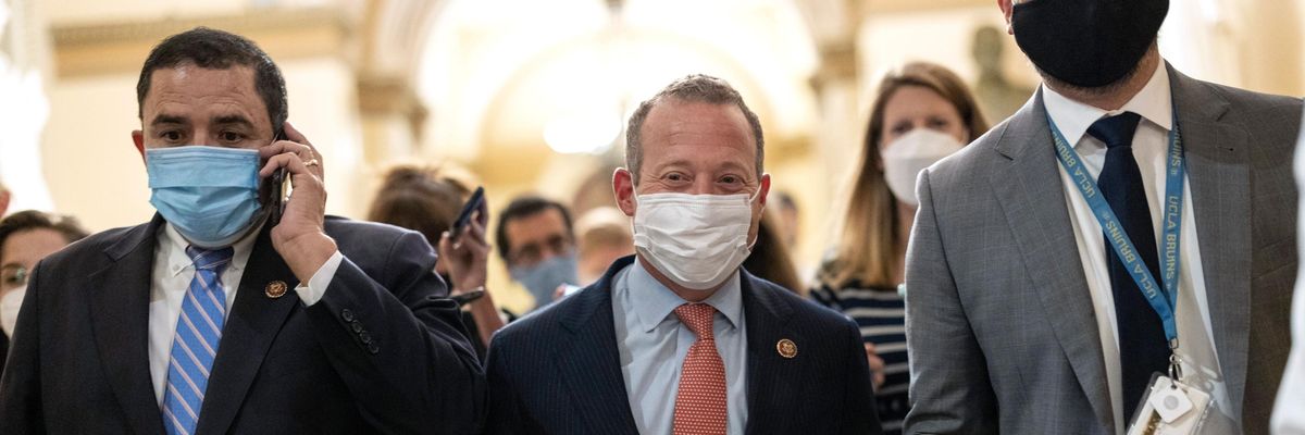 Reps. Henry Cuellar and Josh Gottheimer walk in the U.S. Capitol hallway