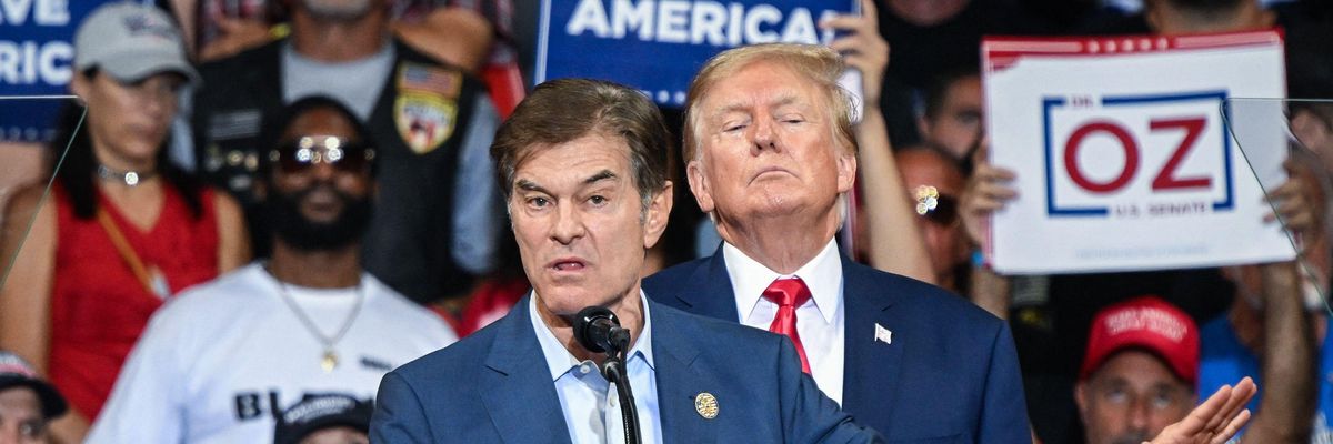 Republican U.S. Senate nominee Mehmet Oz speaks as former U.S. President Donald Trump stands behind him during a campaign rally at Mohegan Sun Arena in Wilkes-Barre, Pennsylvania on September 3, 2022.