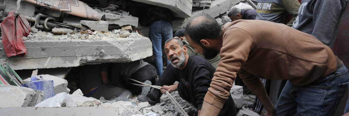 Rescue teams search rubble of Gaza building