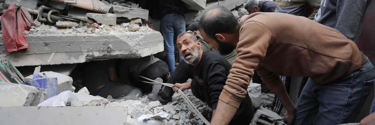 Rescue teams search rubble of Gaza building