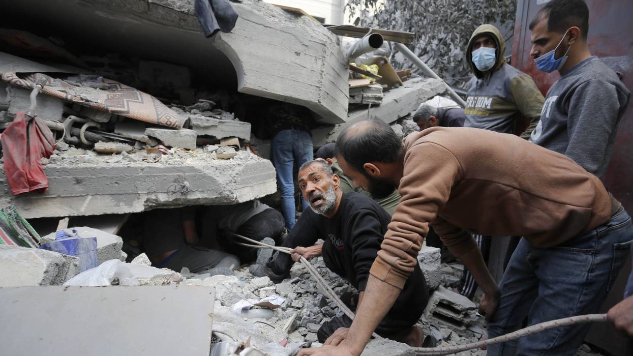 Rescue teams search rubble of Gaza building