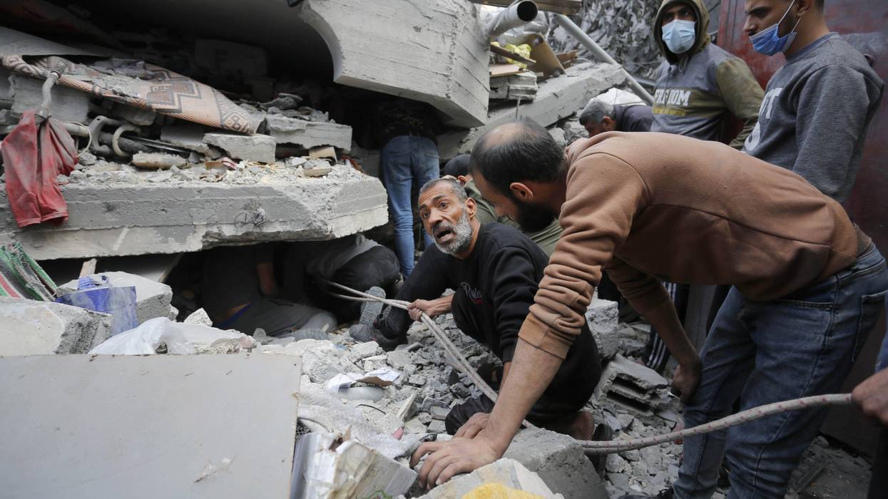 Rescue teams search rubble of Gaza building