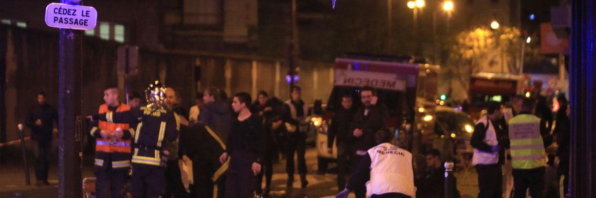 Rescue workers and victims at the site of an attack at a Paris restaurant Friday.