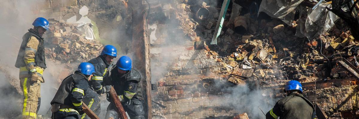 Rescue workers pour water on rubble following Russian attack on Kyiv