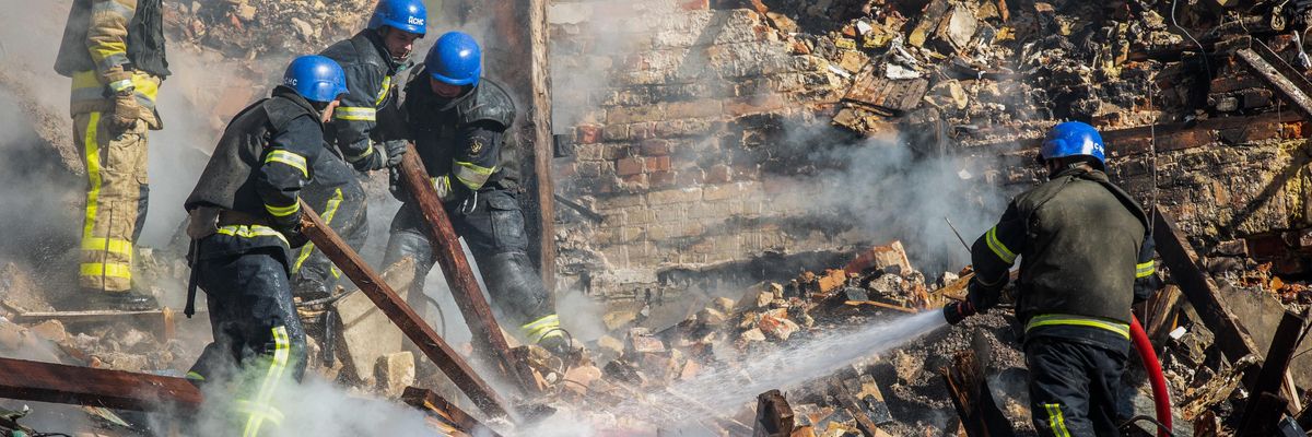 Rescue workers pour water on rubble following Russian attack on Kyiv