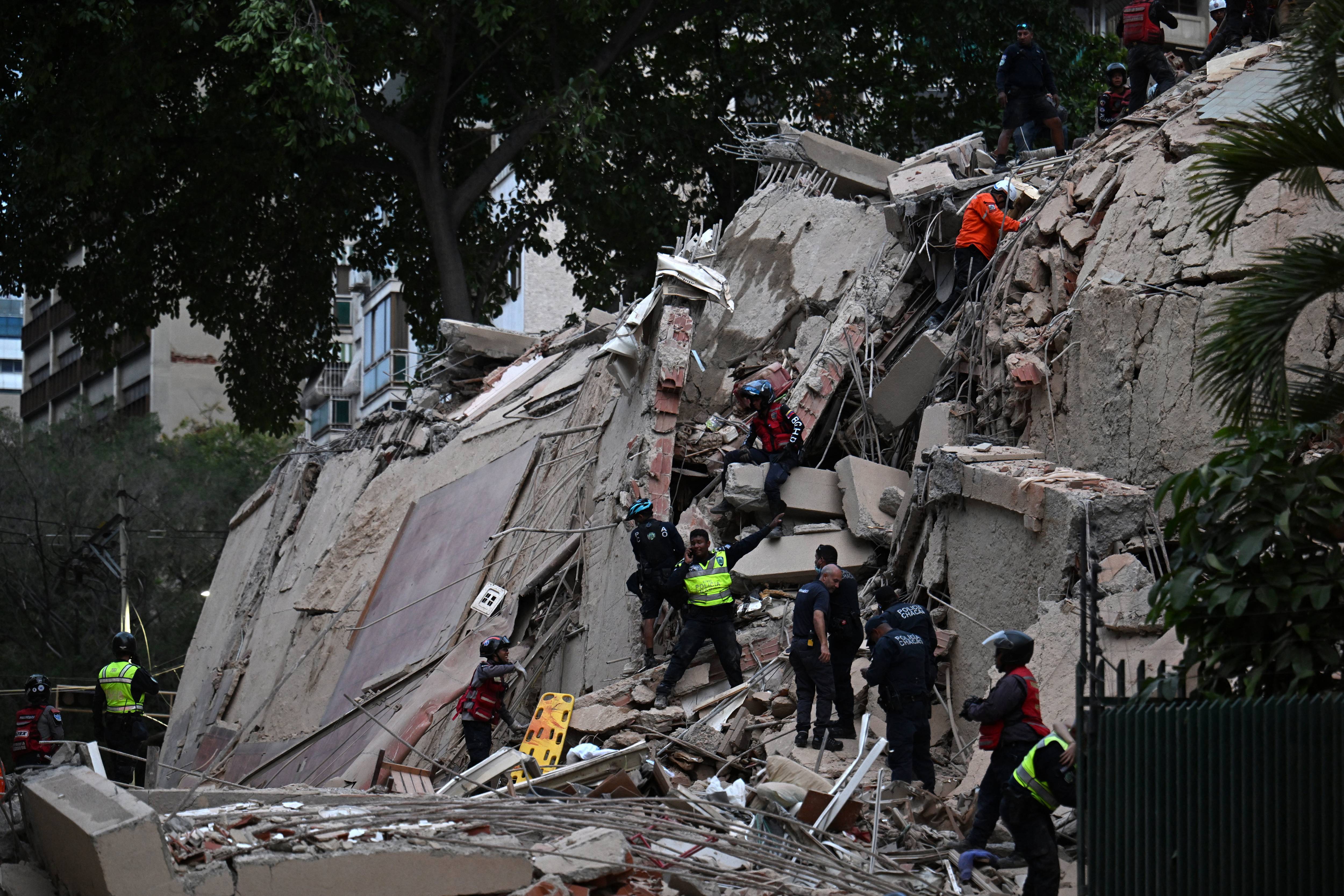 Rescue workers search for survivors of a massive earthquake in Venezuela